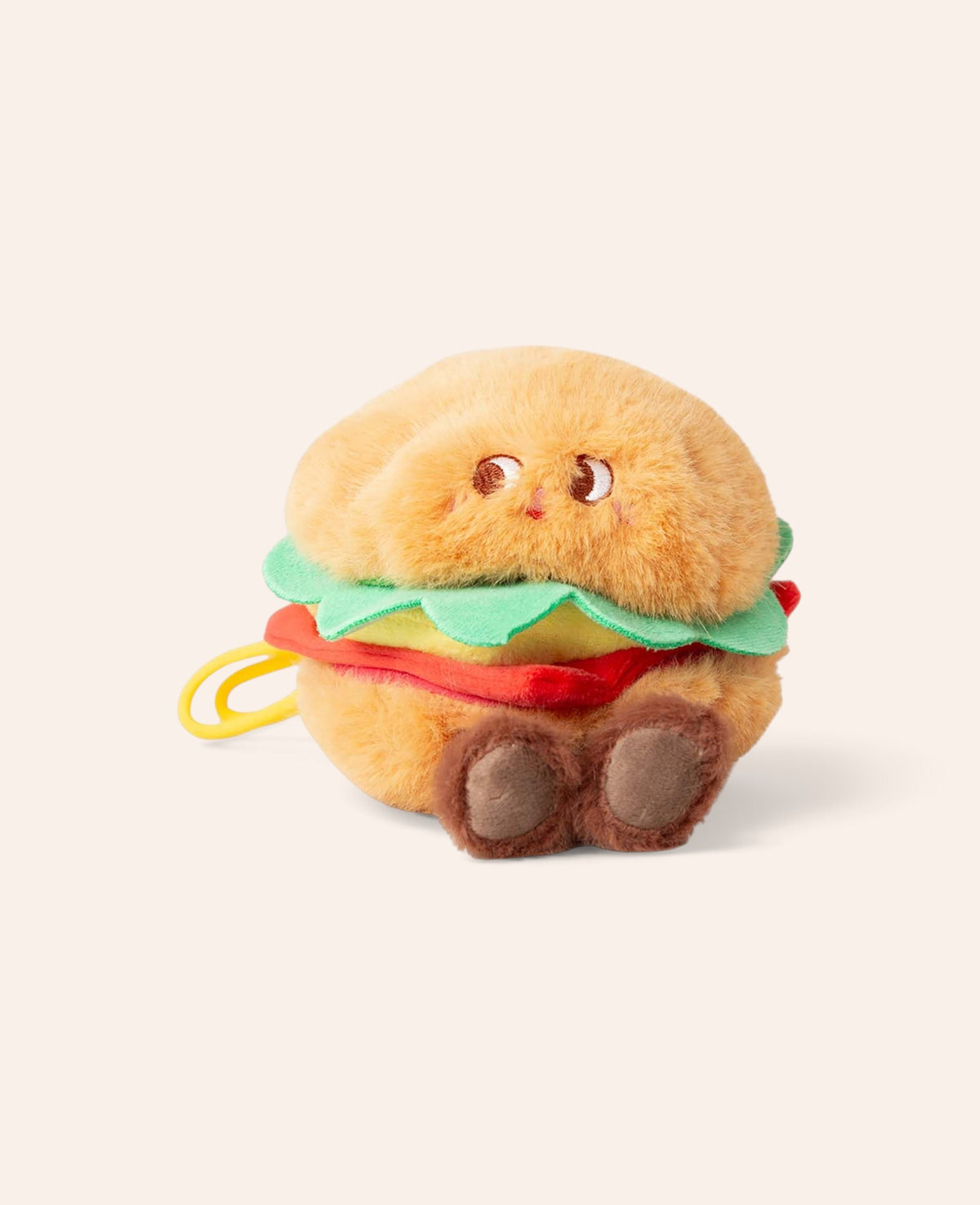 Esmée Taschenanhänger in Form eines flauschigen Plüsch-Burgers mit niedlichem Gesicht und Karabinerhaken.
